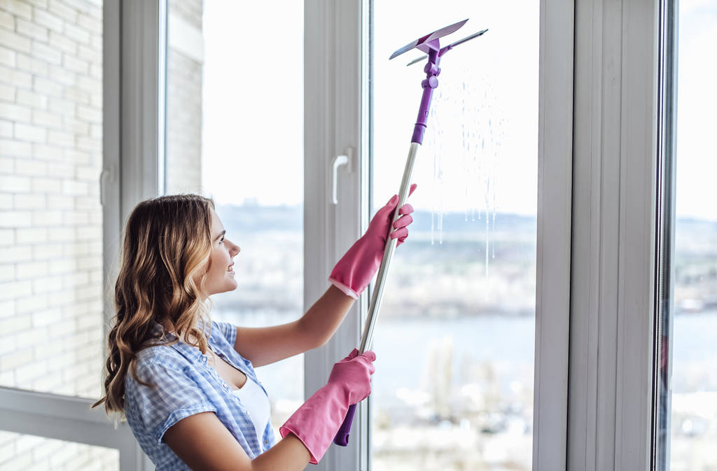 Giovane donna sta facendo pulizia a casa
 - Foto, immagini