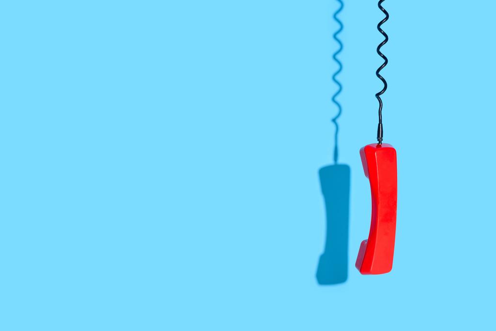 View of old telephone handset on blue background - Photo, Image