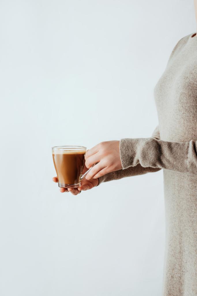 partial side view of woman holding glass cup with coffee isolated on white - Photo, Image