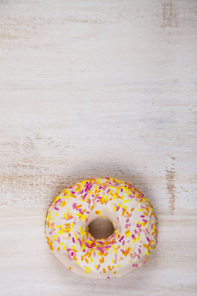 Donut close-up on a wooden background. - Photo, Image