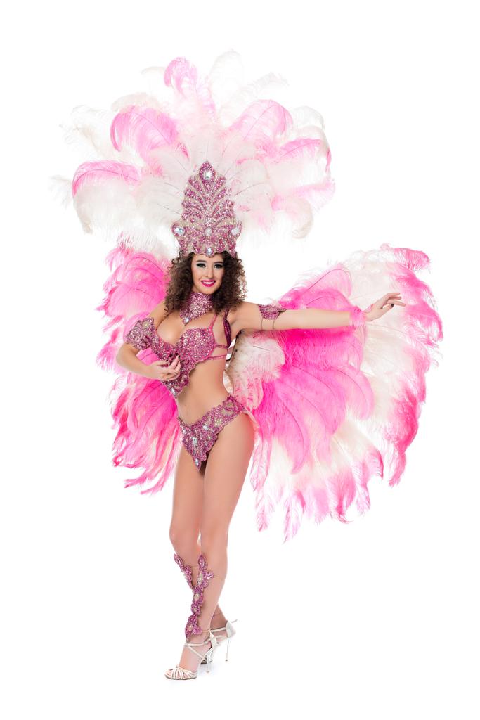 ピンクの羽は、白で隔離のカーニバル衣装で踊る美しい少女 - 写真・画像