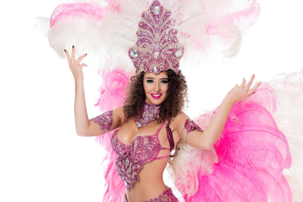 smiling girl posing in carnival costume with pink feathers, isolated on white - Photo, Image