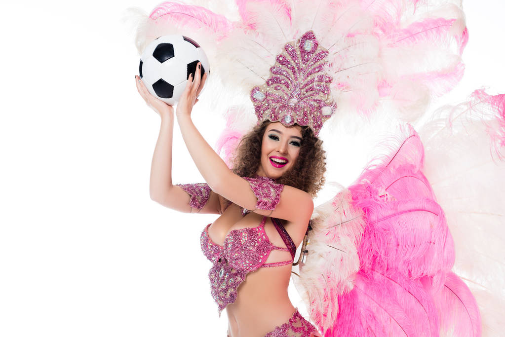 woman in carnival costume with pink feathers holding soccer ball, isolated on white - Photo, Image
