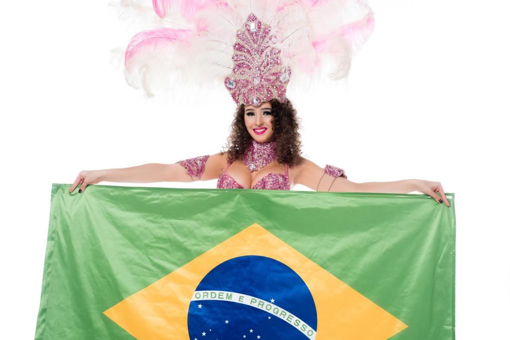 Cheerful woman in carnival costume with pink feathers holds flag of Brasil isolated on white - Photo, Image