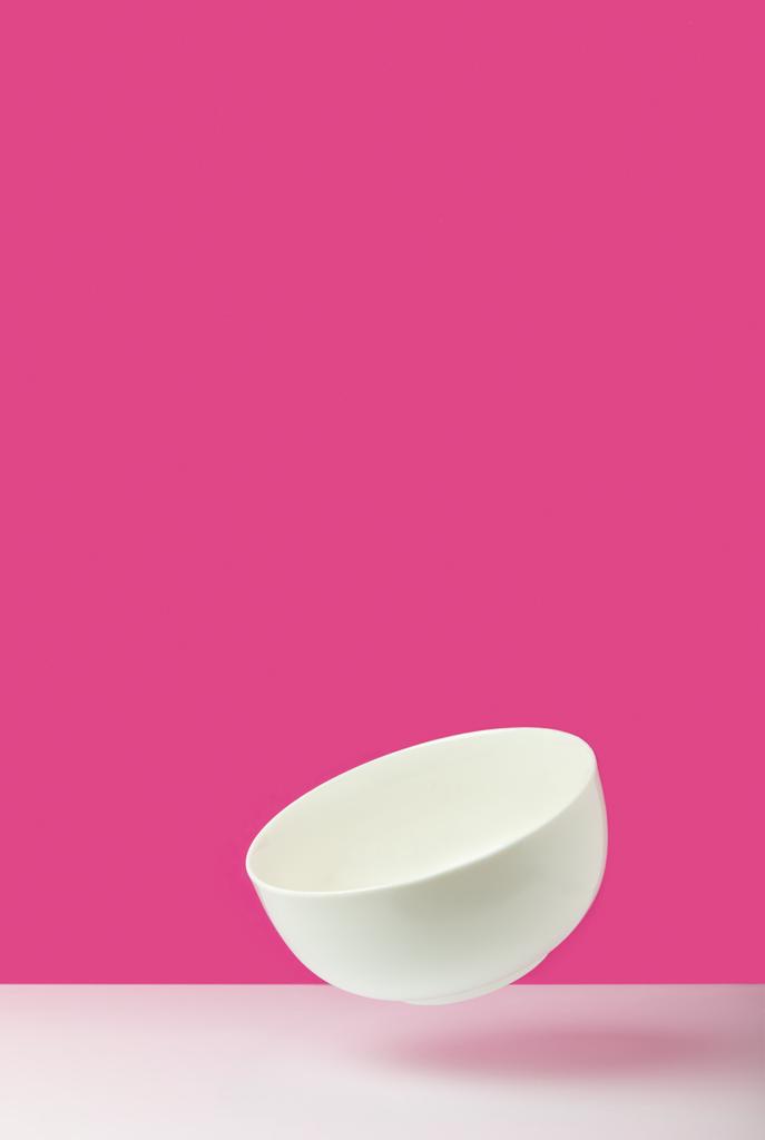 close-up view of empty white bowl on pink   - Photo, Image