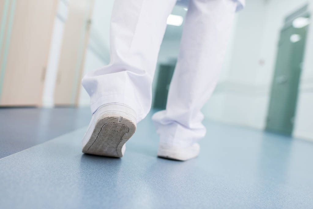 χαμηλό τμήμα του αρσενικό ο γιατρός σε λευκό παντελόνι με τα πόδια στο νοσοκομείο - Φωτογραφία, εικόνα