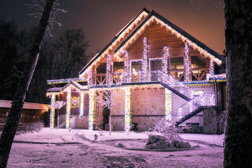 wooden house with garlands in evening in forest - Photo, Image