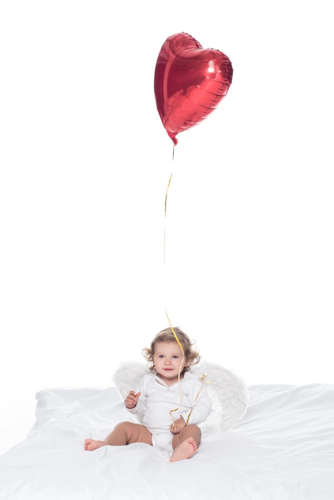baby angel with wings and nimbus holding heart balloon, isolated on white - Photo, Image
