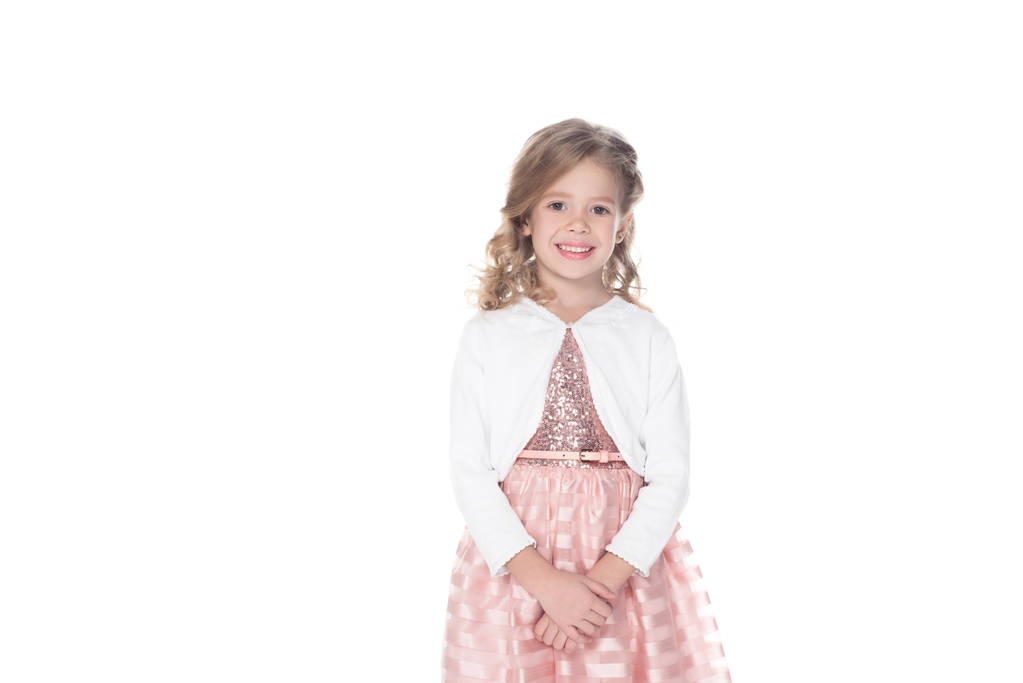 schattige lachende kind in roze jurk, geïsoleerd op wit  - Foto, afbeelding