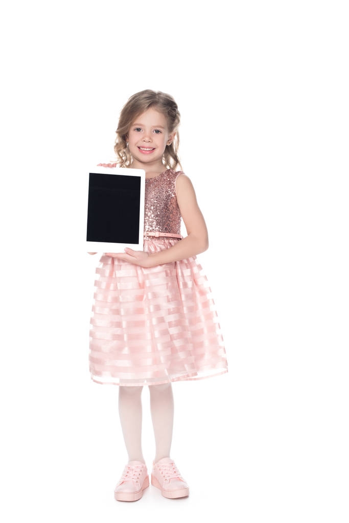 entzückendes Kind präsentiert digitales Tablet mit leerem Bildschirm, isoliert auf weiß - Foto, Bild