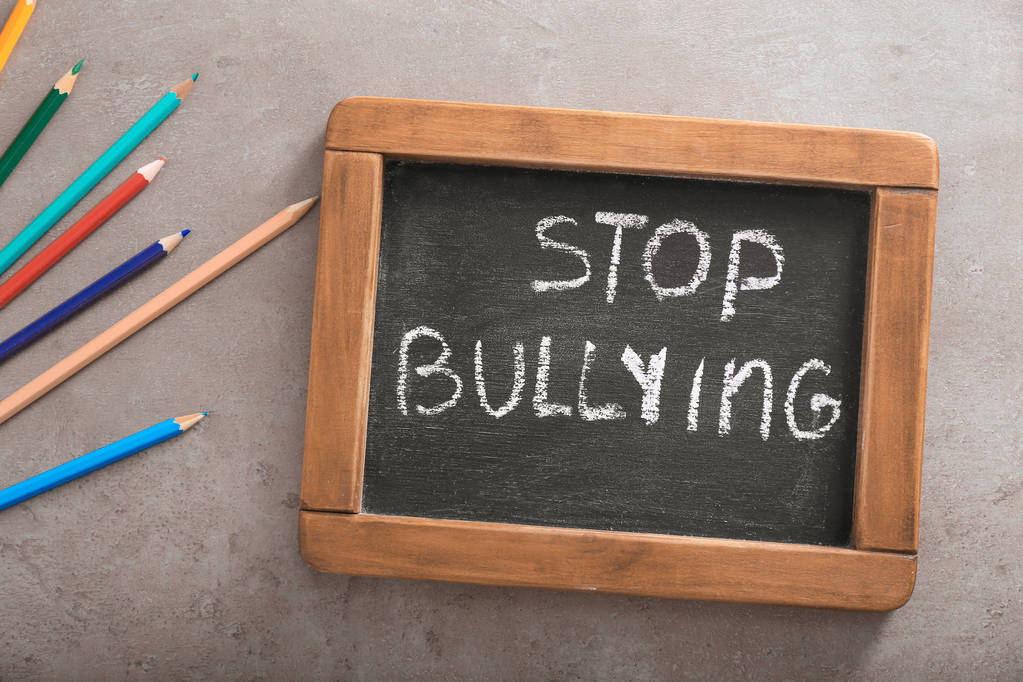 Chalkboard with text STOP BULLYING on grey background - Photo, Image
