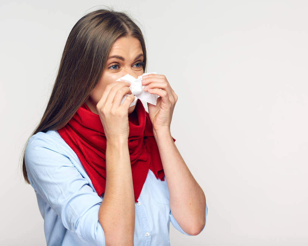 Sick woman with red scarf using tissue.  - Photo, Image
