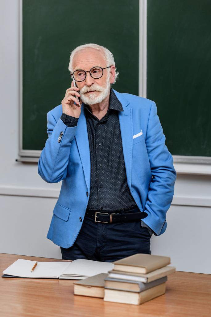 graue Haare Professor spricht per Smartphone und schaut weg - Foto, Bild