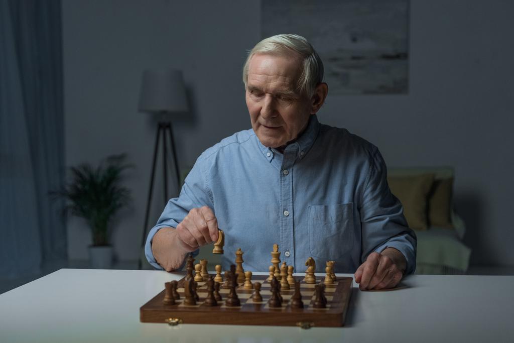 Старший уверенный в себе человек играет в шахматы
 - Фото, изображение