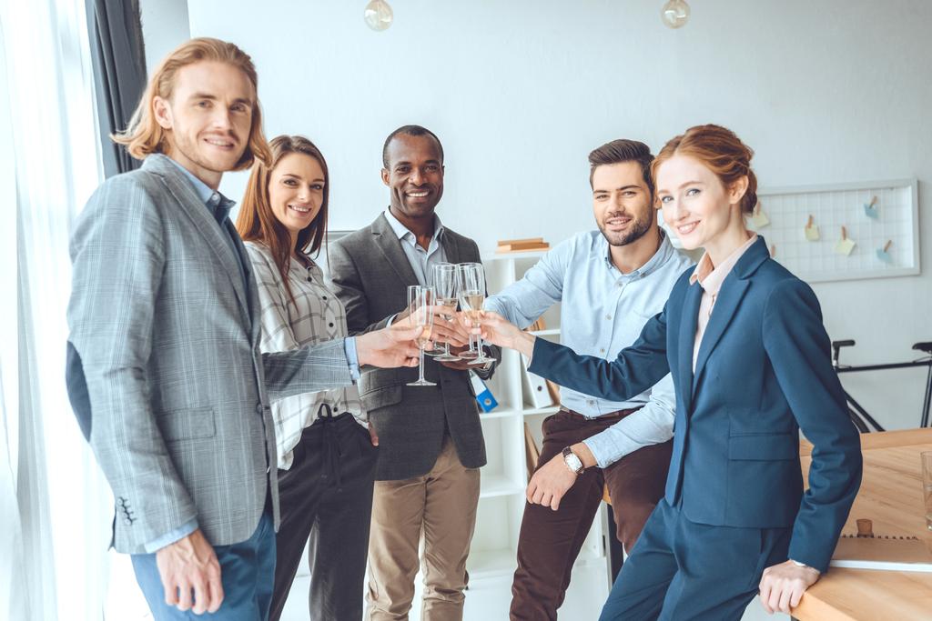 business team celebrating with beverage in glasses at office space   - Photo, Image