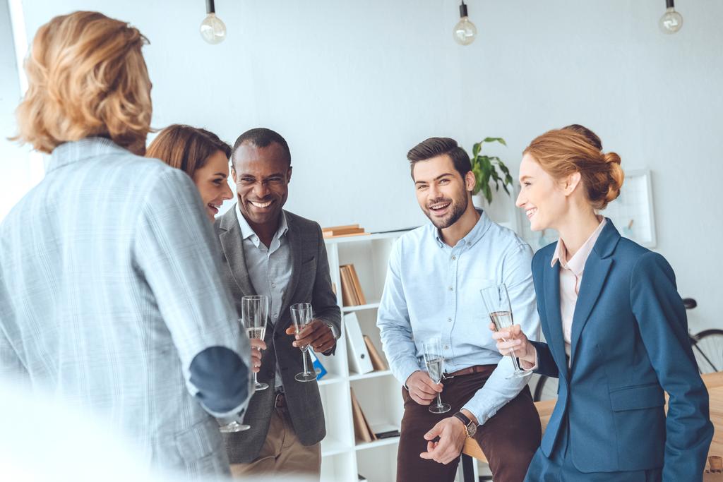 business team celebrating with beverage in glasses at office space - Photo, Image