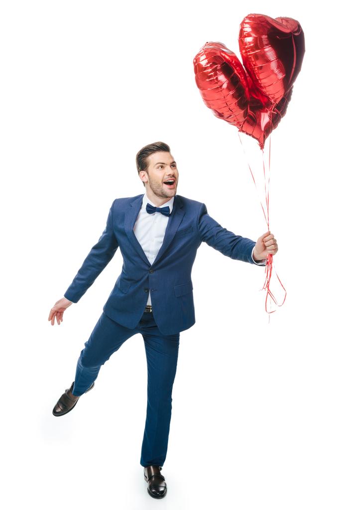 счастливый молодой человек с шарами в форме сердца, изолированными на белом
 - Фото, изображение