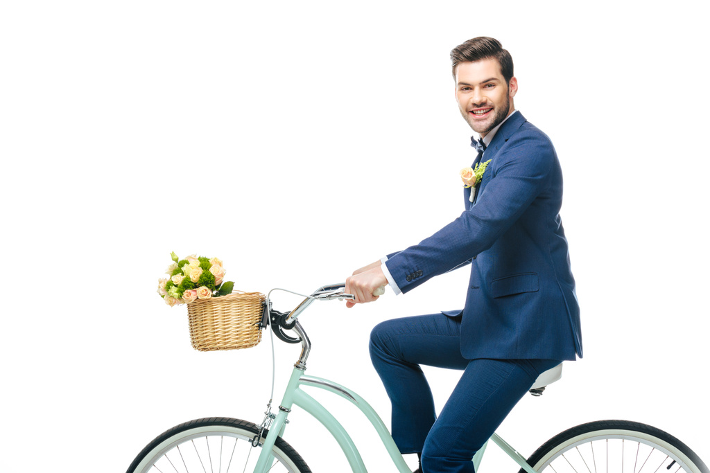 усміхнений наречений у костюмі верхи на ретро велосипеді ізольований на білому
 - Фото, зображення