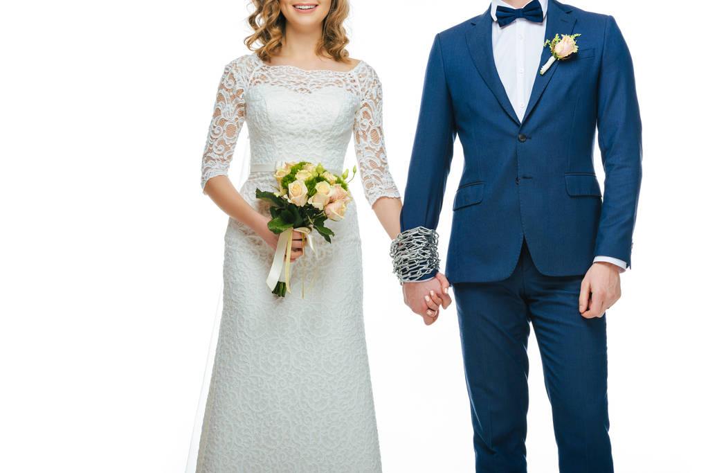 cropped shot of chained wedding couple holding hands isolated on white - Photo, Image