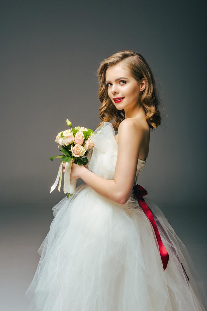 side view of bride in wedding dress with bouquet of flowers - Photo, Image