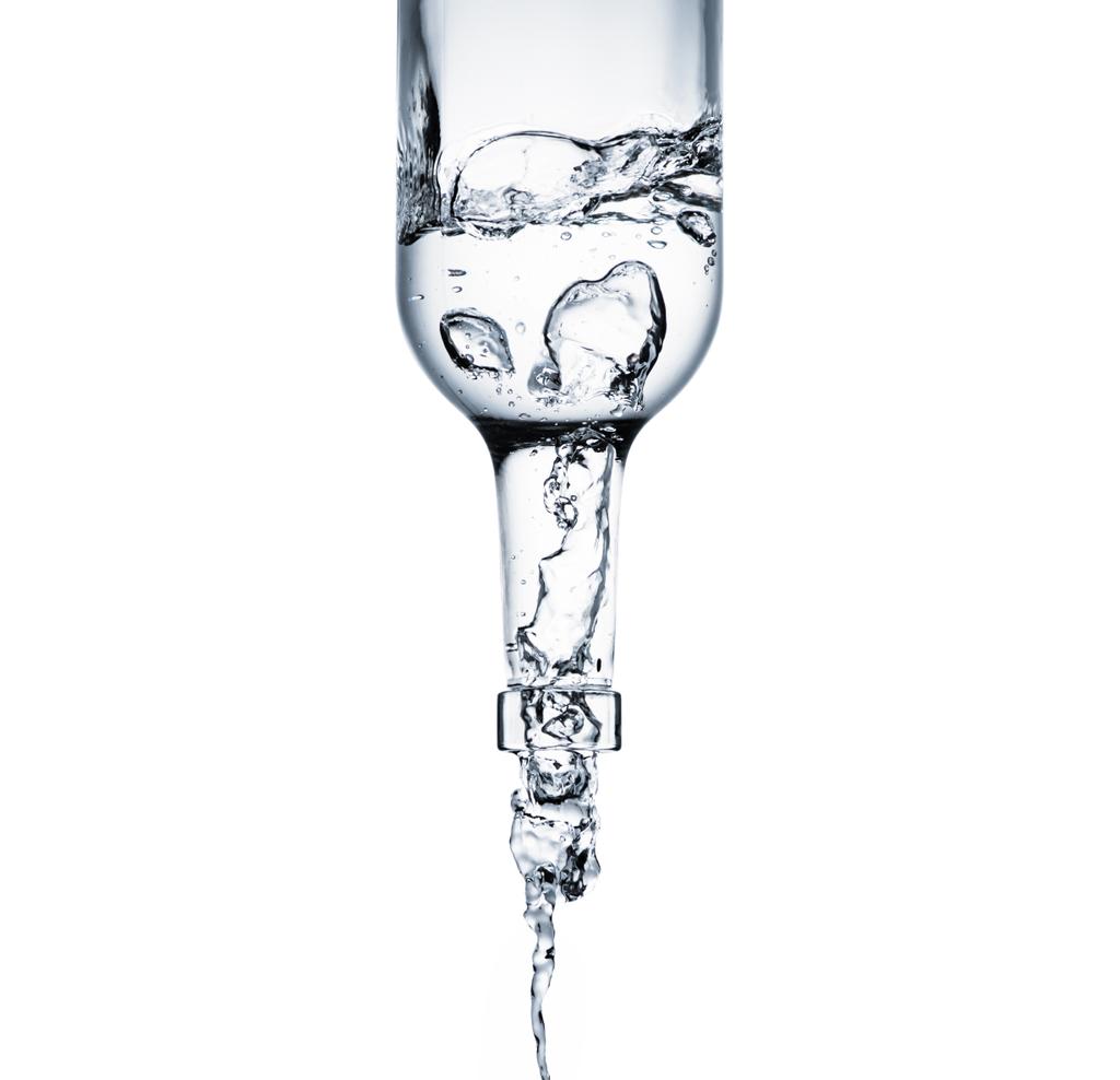 close-up shot of water pouring from glass bottle isolated on white - Photo, Image
