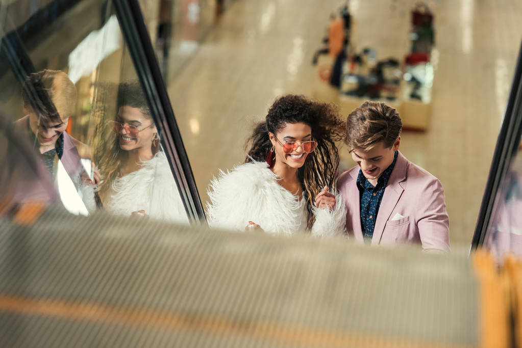 young couple riding escalator at shopping mall - Photo, Image