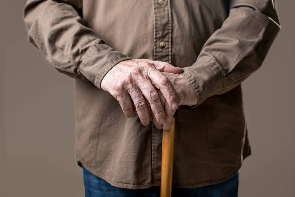 Hands of elderly male holding cane - Photo, Image