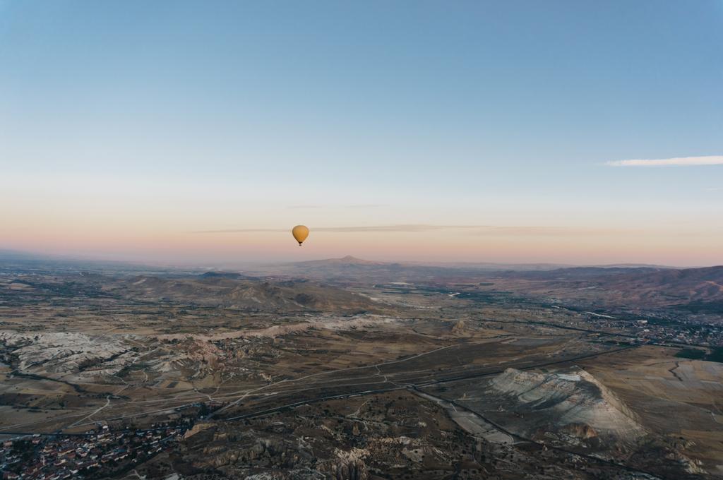 one hot air balloon flying Goreme national park, fairy chimneys, Cappadocia, Turkey - Photo, Image