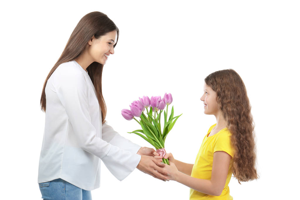 Cute little girl giving tulip bouquet to her mom on white background. Mother's day celebration - Photo, Image