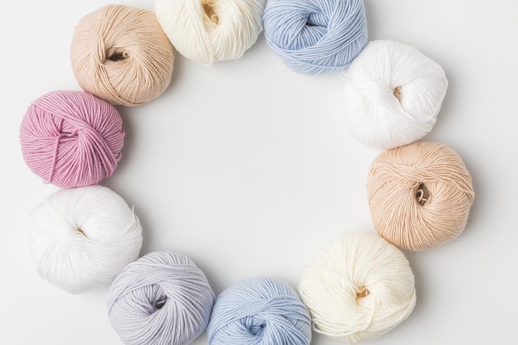 top view of circle of colored yarn balls on white background   - Photo, Image