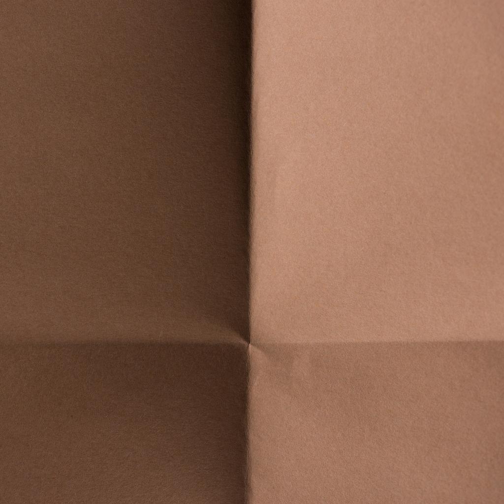 Close-up shot hnědého barevného skládané papíru pro pozadí - Fotografie, Obrázek