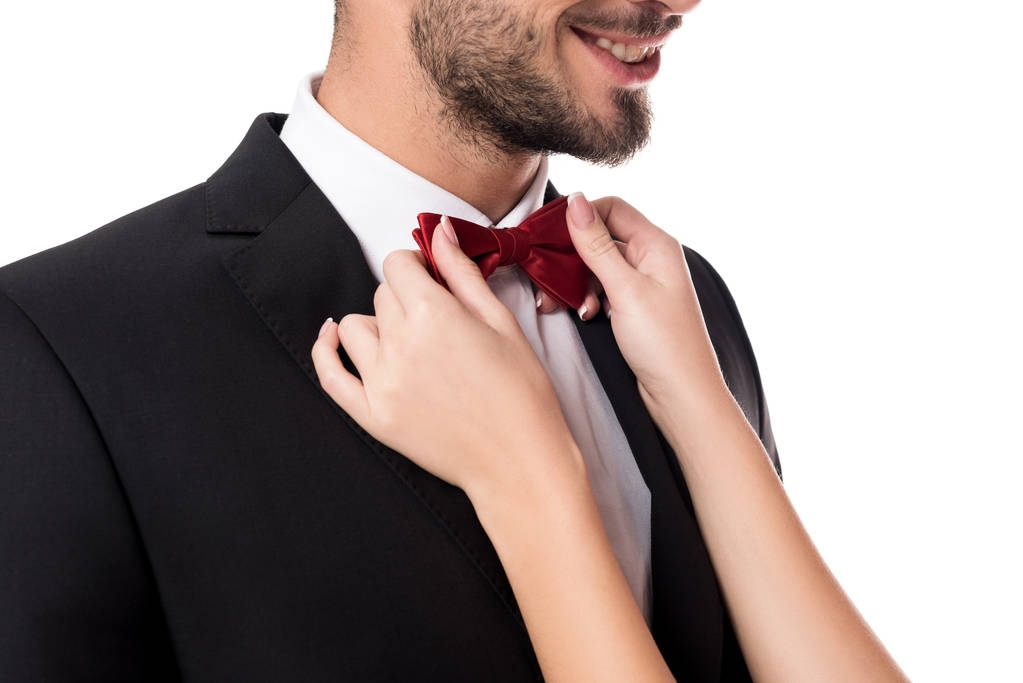 cropped image of girlfriend fixing boyfriends tie bow isolated on white - Photo, Image