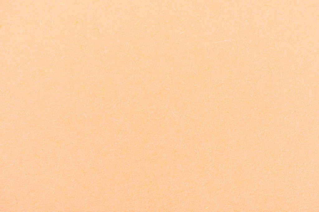 Textur aus pfirsichgelbem Farbpapier als Hintergrund - Foto, Bild