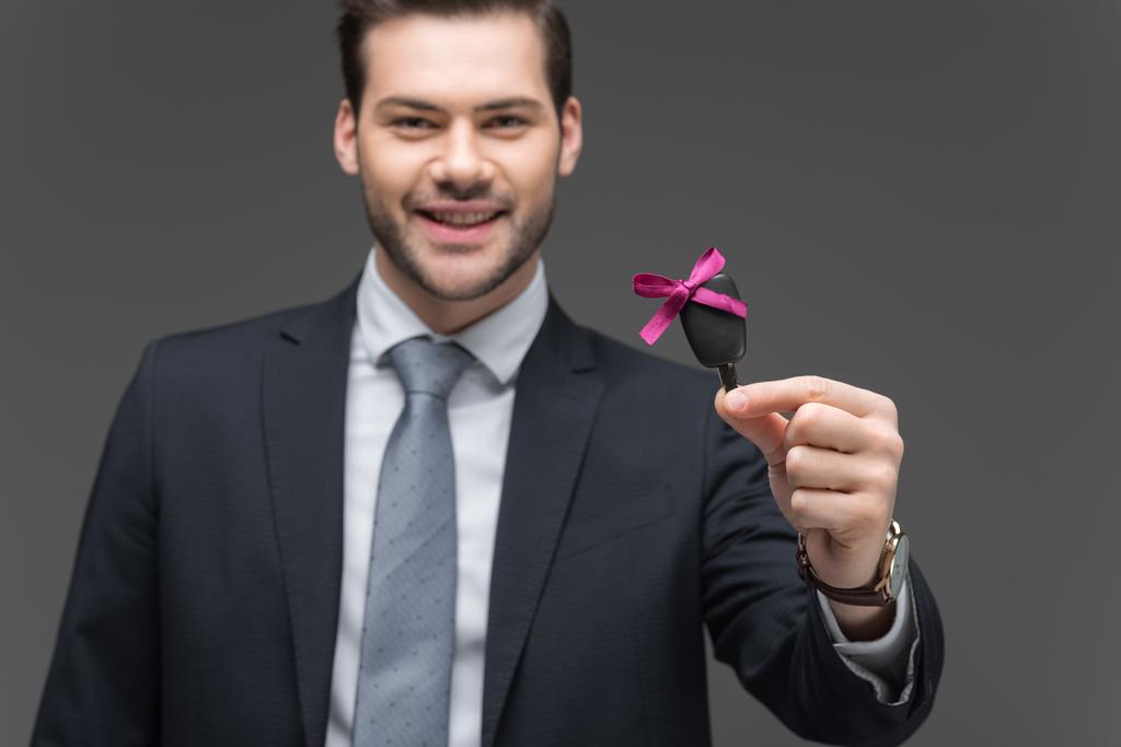 cheerful businessman holding car key, isolated on grey - Photo, Image