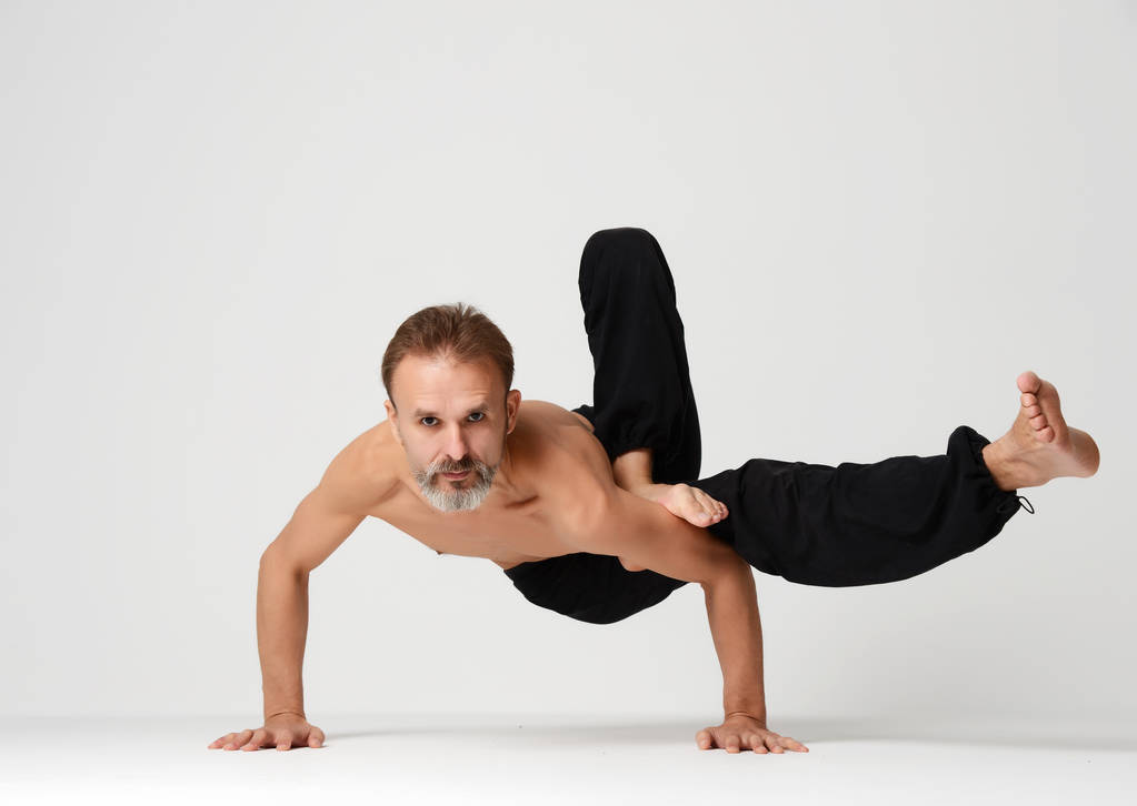 Homme pratiquant le yoga pose de danse asana classique debout sur la main
 - Photo, image