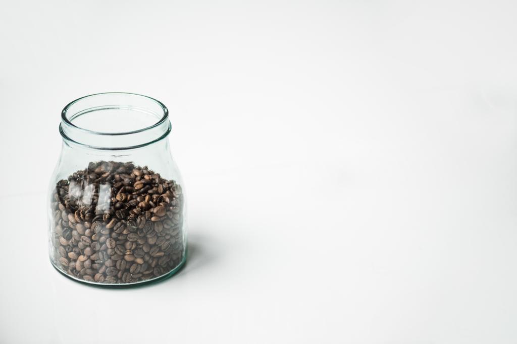 botella de vidrio con granos de café en blanco
 - Foto, Imagen