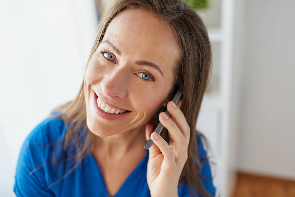 woman calling on smartphone at office or home - Photo, Image