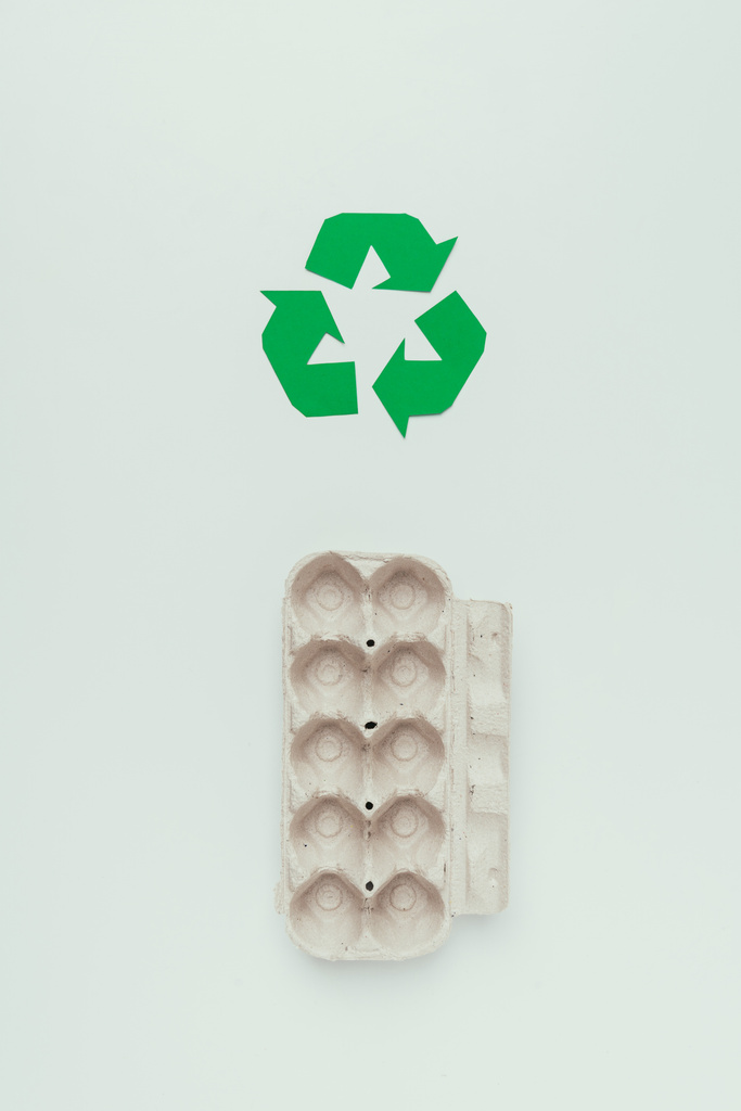 top view of recycle sign and empty carton egg box isolated on grey - Photo, Image