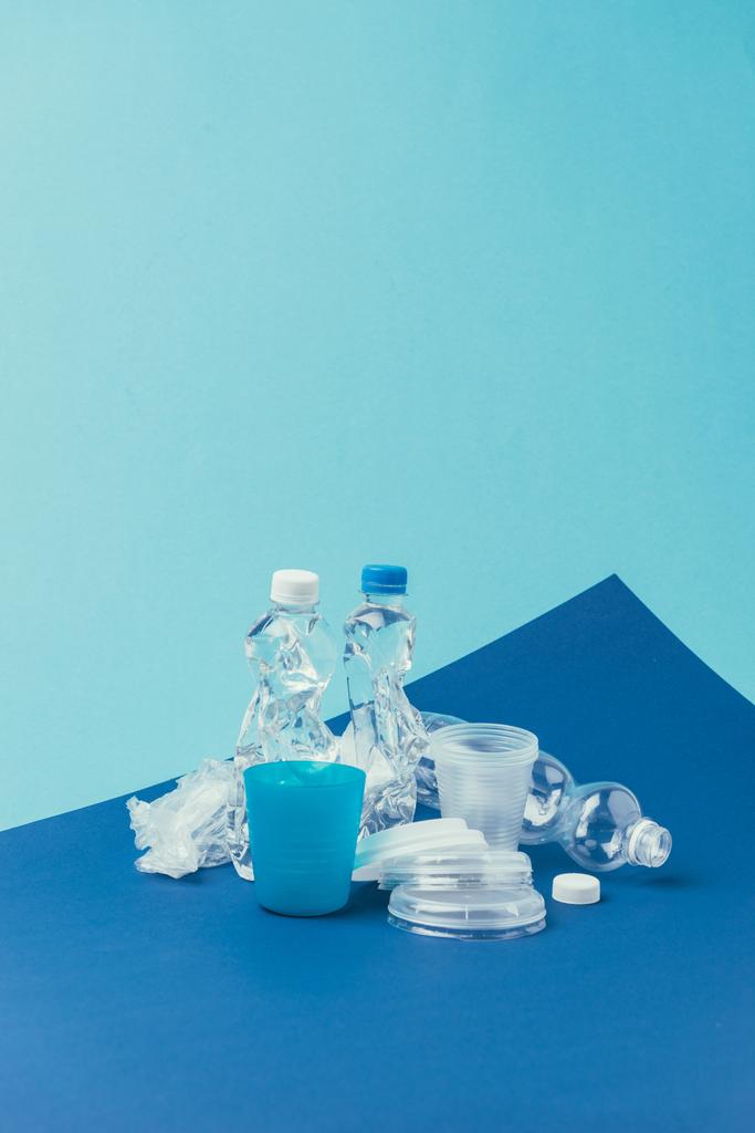 vue rapprochée de diverses poubelles en plastique sur fond bleu, concept de recyclage
 - Photo, image