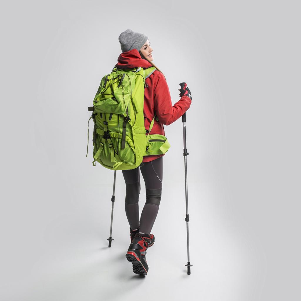 beautiful happy traveler with backpack and hiking equipment, isolated on grey - Photo, Image