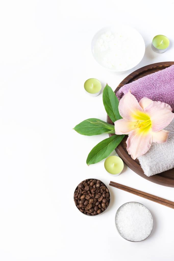 Spa setting of towel, flower, coffee on white. Copy space. Relax. - Photo, Image