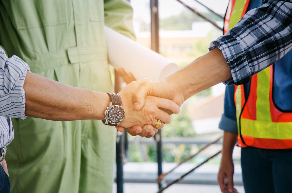 engineer and technician contractor shaking hands after finishing up a business meeting to greeting start up project contract in construction site building, successful, partnership, teamwork concept - Photo, Image