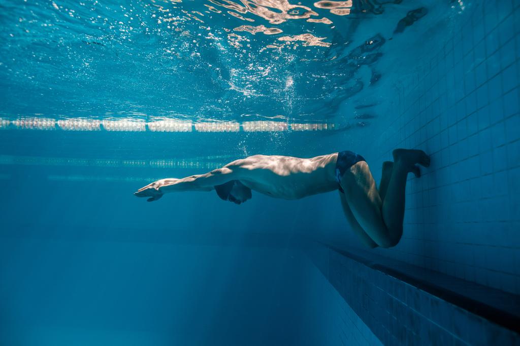 underwater picture of male swimmer swimming i swimming pool - Photo, Image