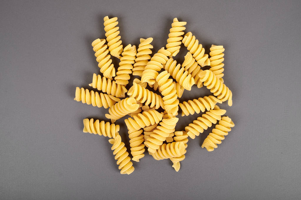 uncooked fusilli pasta noodles isolated on grey background - Photo, Image