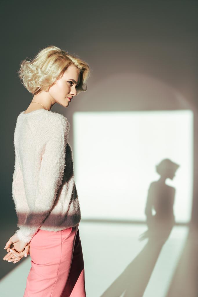 beautiful blonde girl looking away while posing in studio - Photo, Image