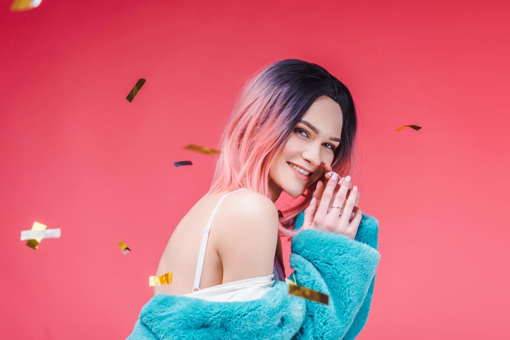 щаслива красива дівчина позує в синьому шубці, ізольована на рожевому з конфетті
 - Фото, зображення