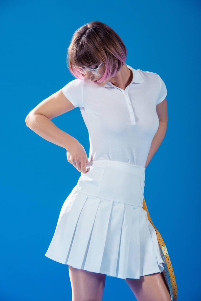 tennis player fixing sportswear isolated on blue - Photo, Image