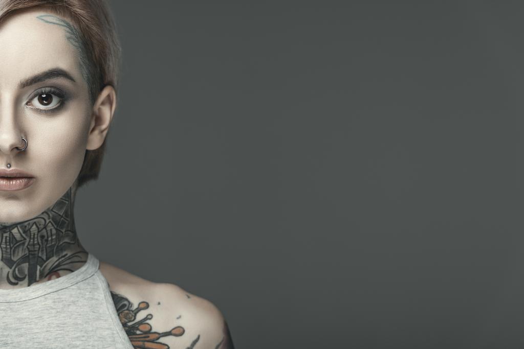 cropped view of beautiful tattooed girl, isolated on grey - Photo, Image