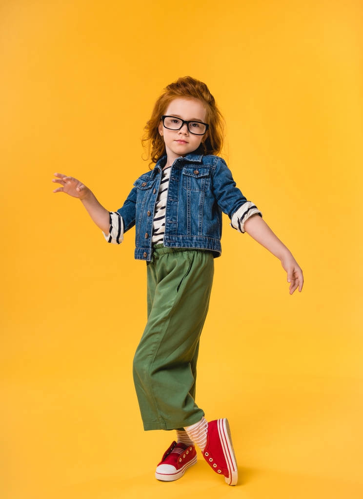 cute little kid in eyeglasses dancing isolated on yellow - Photo, Image