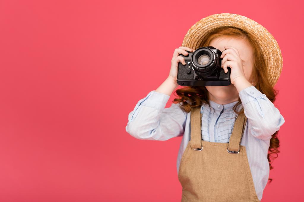 obscured view of child holding photo camera isolated on pink - Photo, Image